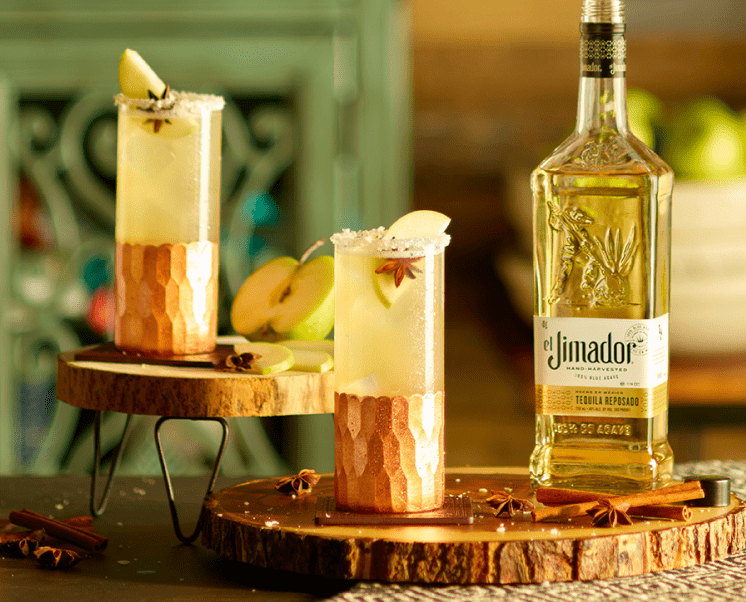 el Jimador El Otono cocktails on a table with an apple slice and el Jimador Reposado bottle.