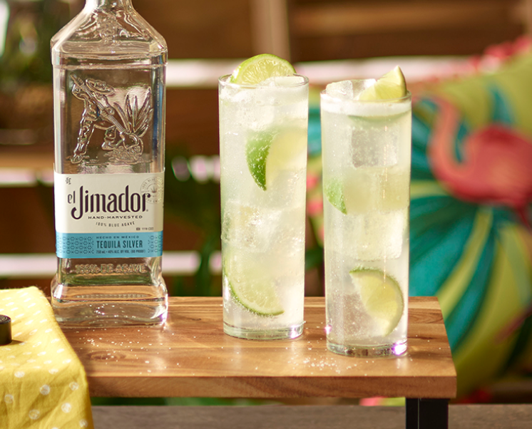 el Jimador Lime Paloma cocktails on a table with an el Jimador Silver bottle.