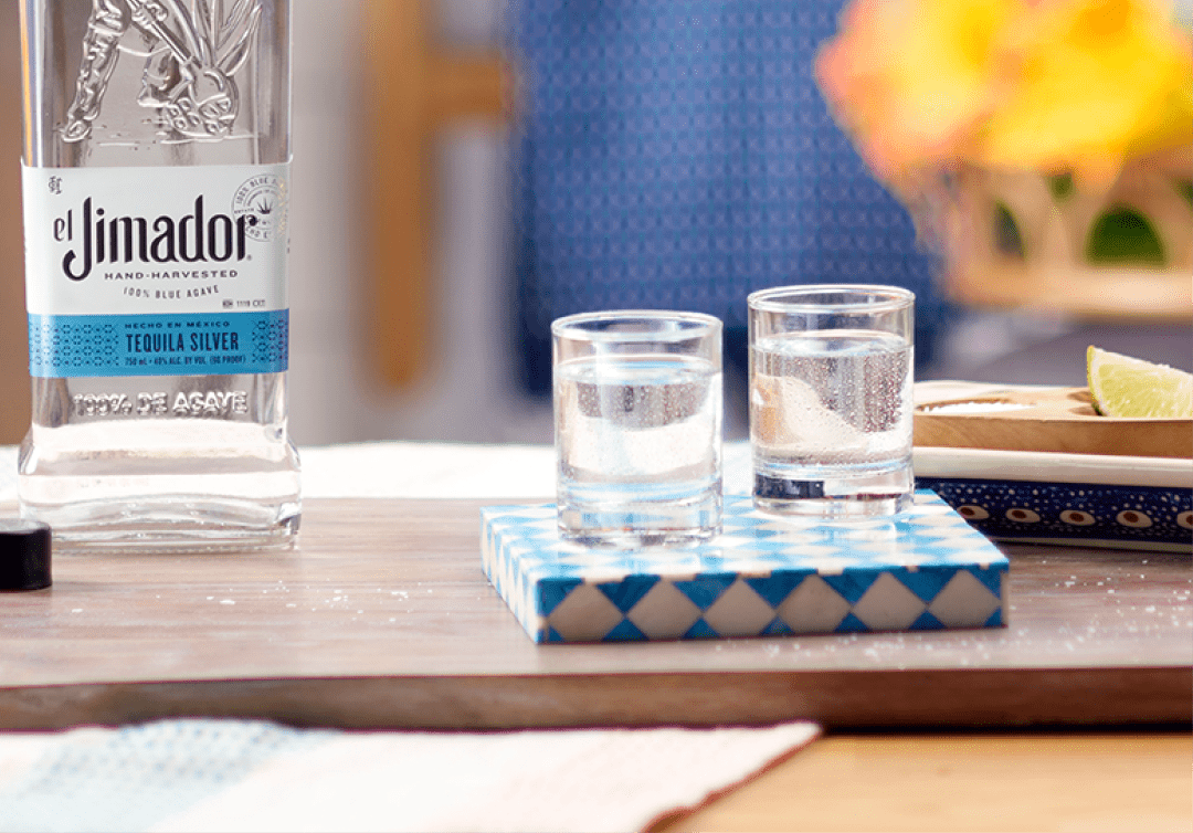 el Jimador Silver in two shot glasses on a table with an el Jimador Silver bottle.