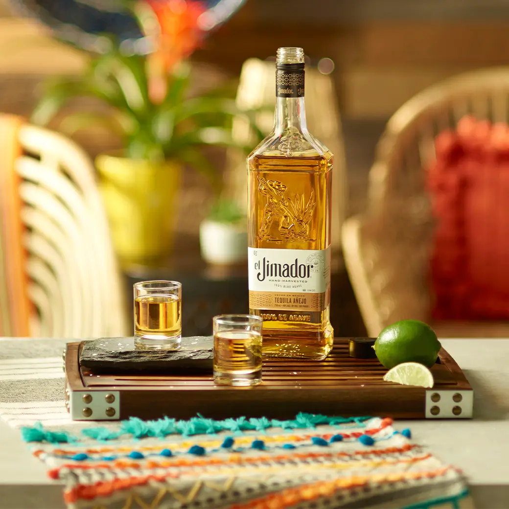An image of two shots along with a bottle of el Jimador Anejo tequila